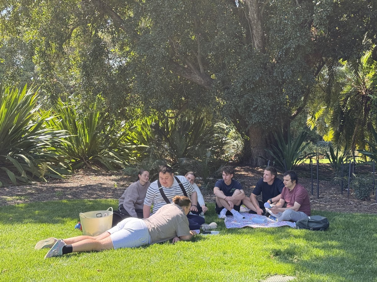 A group of participants and support workers sharing a moment together